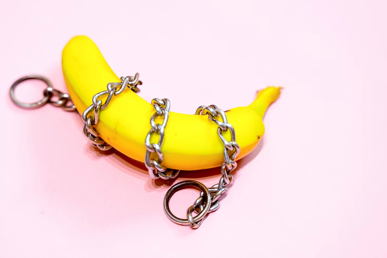 A metal chain wrapped around a banana