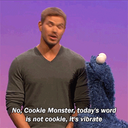 Man telling Cookie Monster, “No, Cookie Monster, today;s word is not cookie, it’s vibrate.”