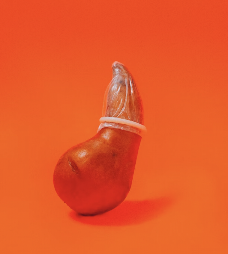 A pear with a condom on it.